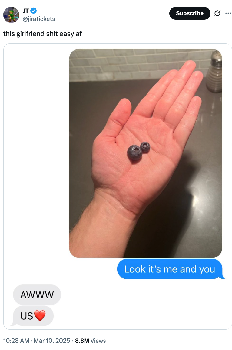 Person holding 2  blueberries successful  hand; substance   messages expressing affection shown below