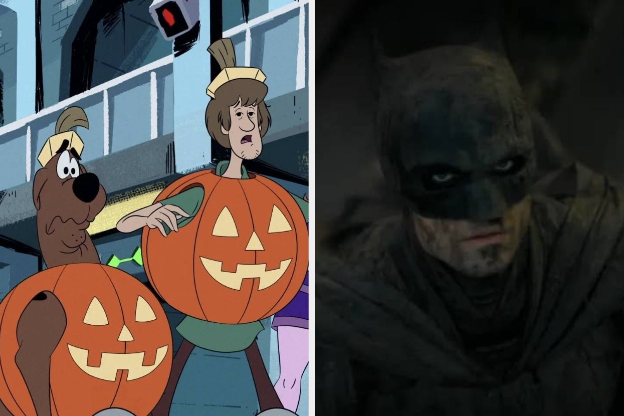 Scooby-Doo and Shaggy in pumpkin costumes beside Batman in a dim setting