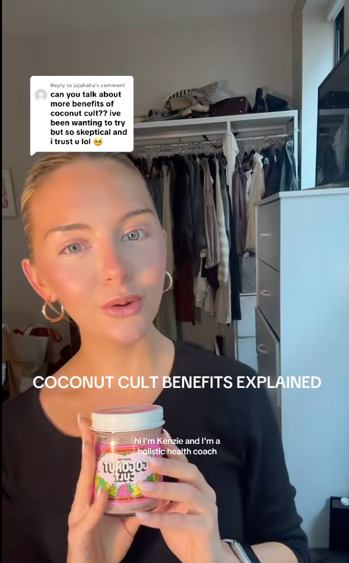 Person explaining the benefits of a jar of coconut yogurt, with text overlay: "hi I'm Kenzie and I'm a holistic health coach."