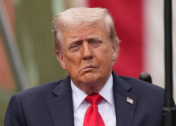 I don’t know who this is, but the image shows a person in a suit and tie, looking serious