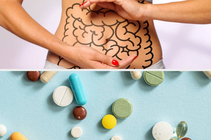 A person touches their abdomen with an intestine diagram, above scattered pills on a surface, suggesting a focus on gut health and supplements