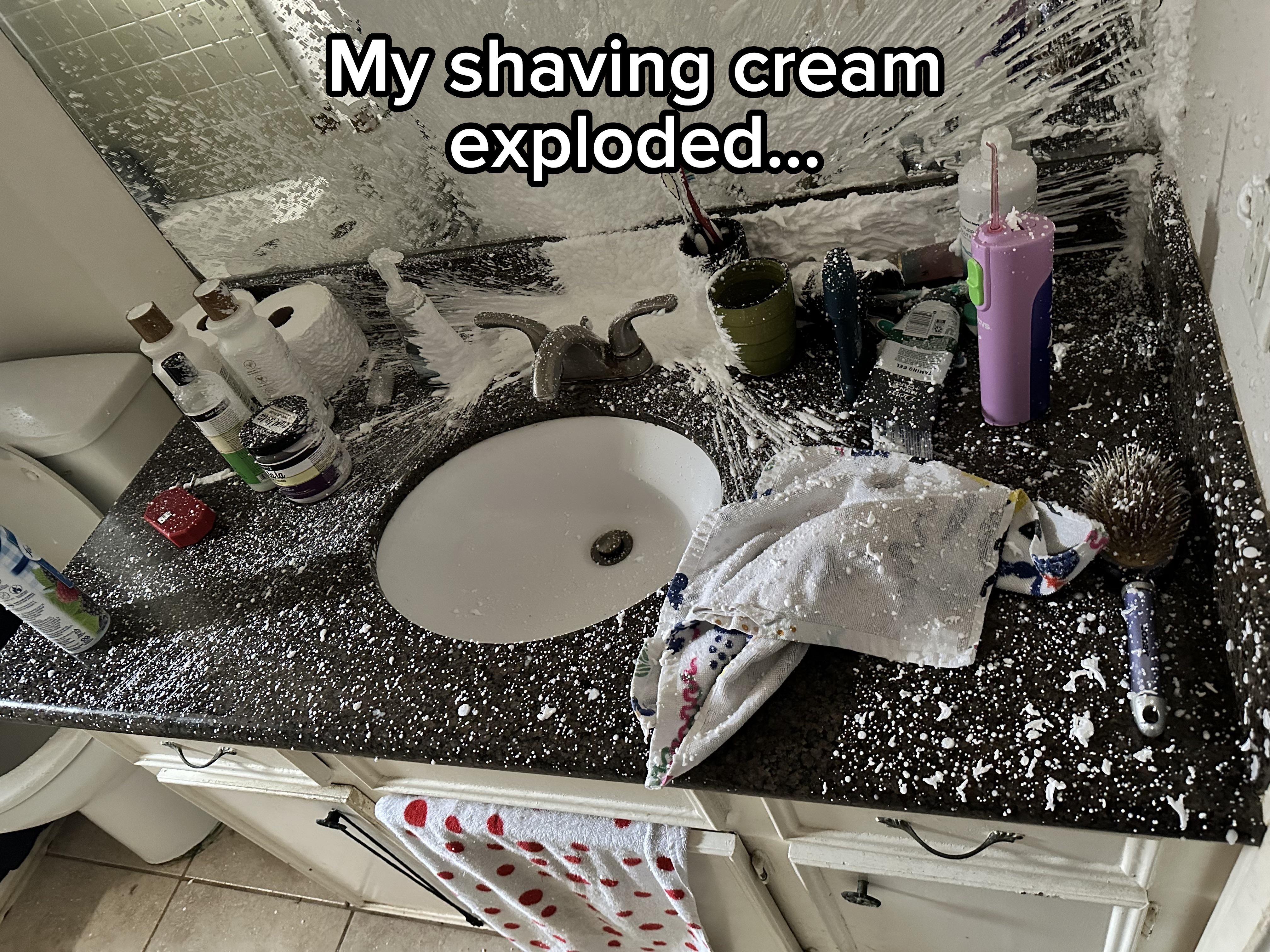 Bathroom countertop covered in splattered toothpaste and toiletries