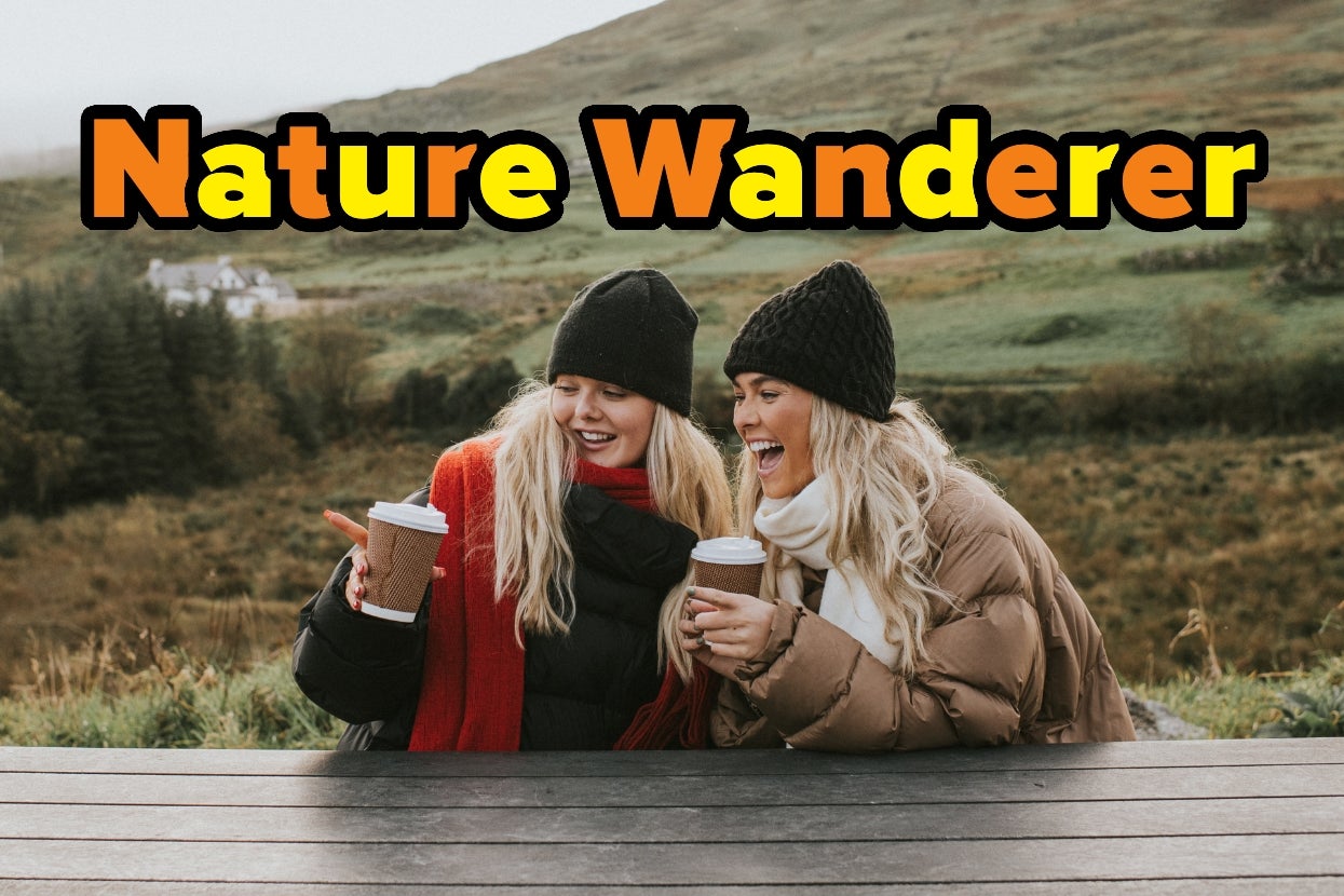 Two people in winter clothing, smiling and holding cups, are seated outdoors on a bench with a hilly landscape in the background. Text reads "Nature Wanderer."