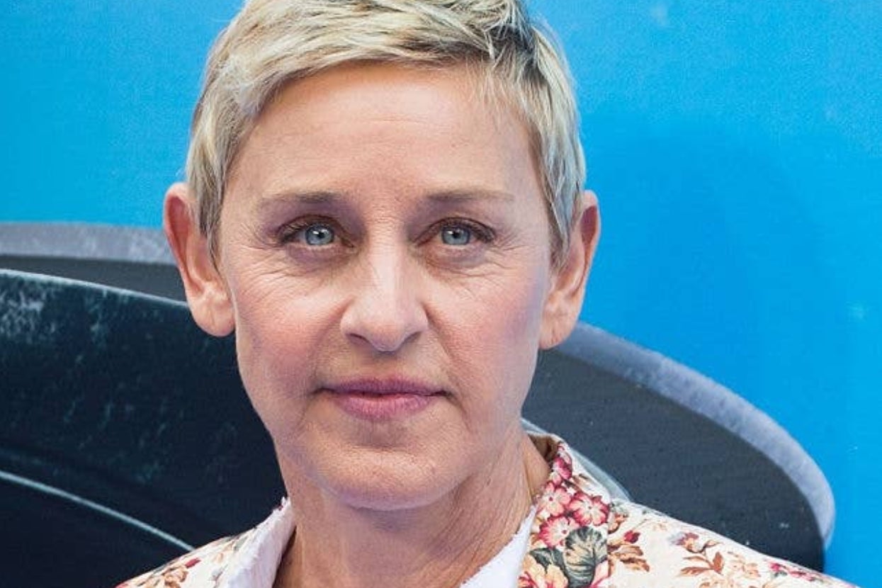 Person with short hair wearing a floral-patterned jacket at a celebrity event