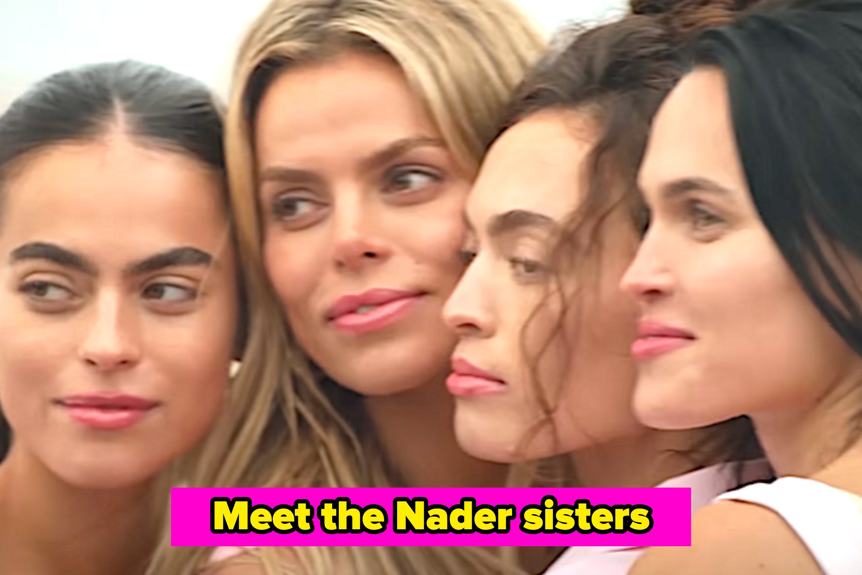 Four women pose for a selfie on a street. One wears a white dress, others in casual and formal attire. They appear confident and stylish