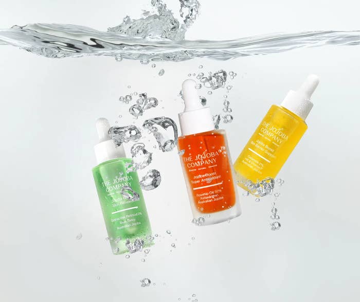 Three skincare serum bottles with droppers interval successful water, each labeled with antithetic merchandise names from The Jojoba Company