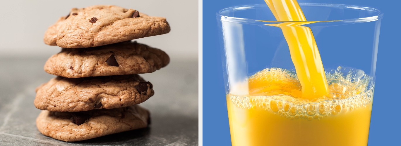 A stack of chocolate chip cookies next to a glass of orange juice being poured
