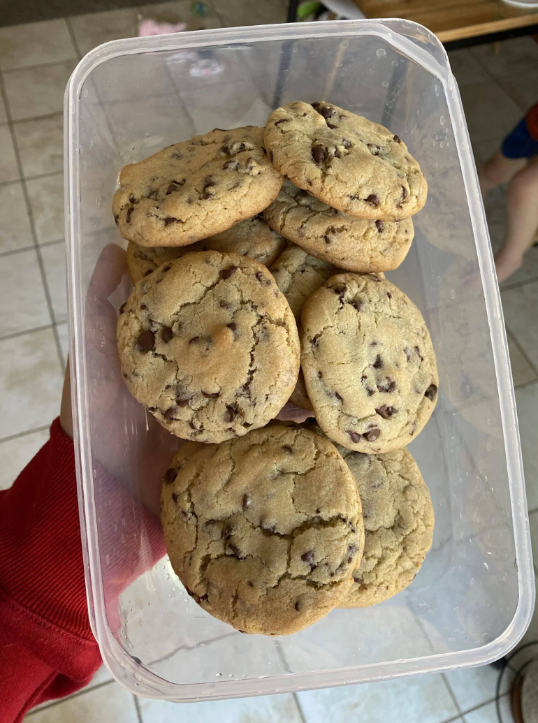 Screenshot of a Reddit post titled "Not the best photo, but my husband made PERFECT chocolate chip cookies" showing a container of cookies