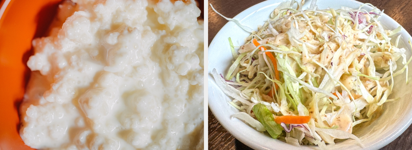 A bowl of creamy mashed potatoes next to a plate of shredded cabbage and carrot salad