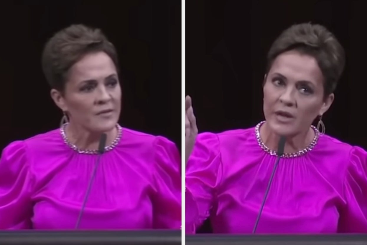 Person speaking at a podium, wearing a formal, puffy-sleeved top with a beaded neckline, gesturing during their speech