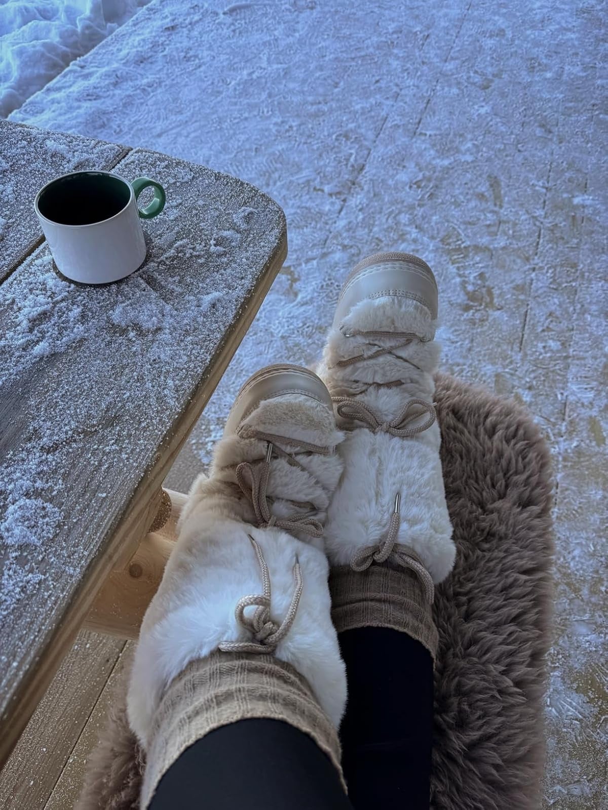 Cozy fur boots and lukewarm  socks connected  a seat  beside a snow-dusted array  with a java  cup