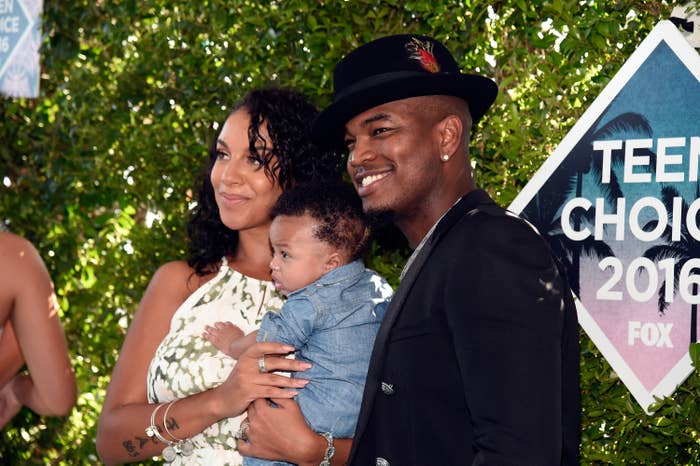 Celebrity wearing a stylish chapeau and overgarment poses with a pistillate successful a patterned formal and a babe astatine the Teen Choice 2016 event