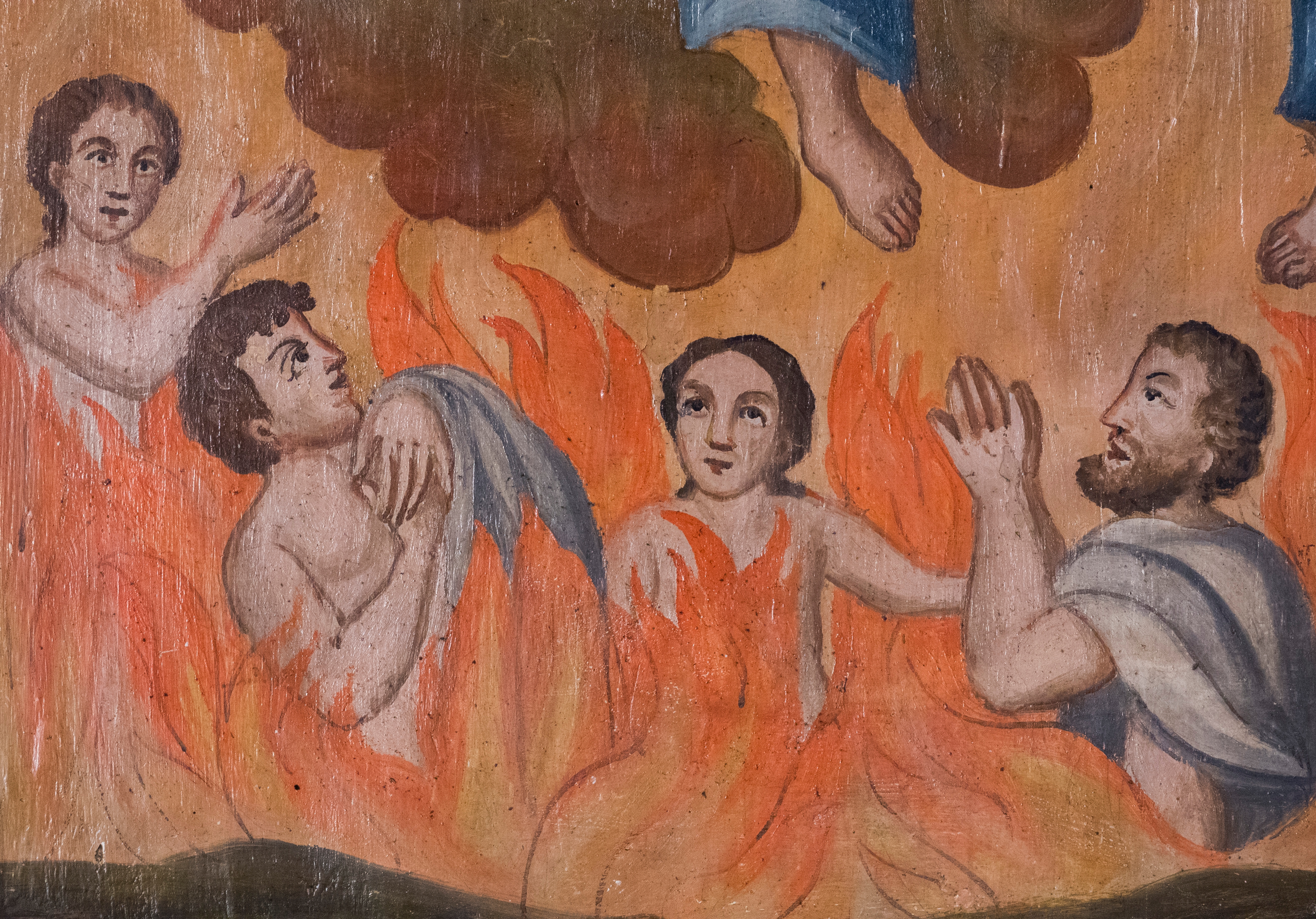 Religious painting depicting people in flames, looking upward with expressions of appeal. The detail suggests a scene of spiritual significance