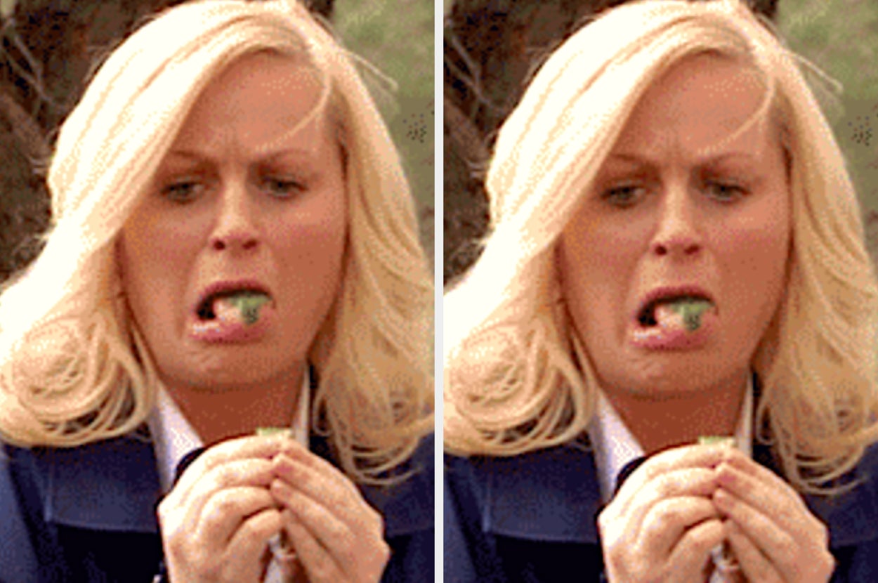 Two people making funny faces while eating; one struggles with greens, the other joyfully eats spaghetti