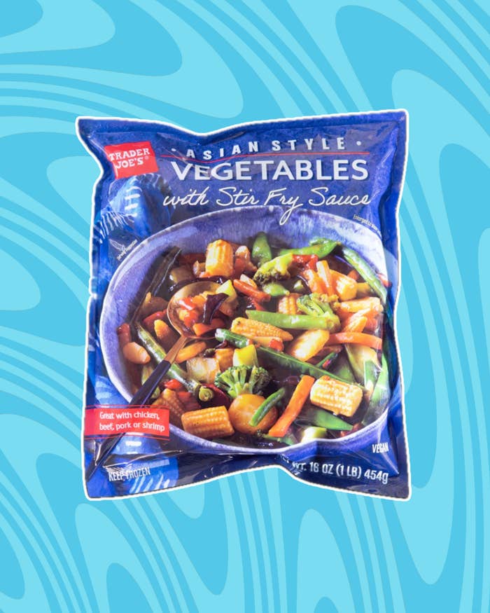Trader Joe&#x27;s Asian Style Vegetables package with Stir Fry Sauce, featuring baby corn, snap peas, and carrots. Suggests pairing with meat or shrimp