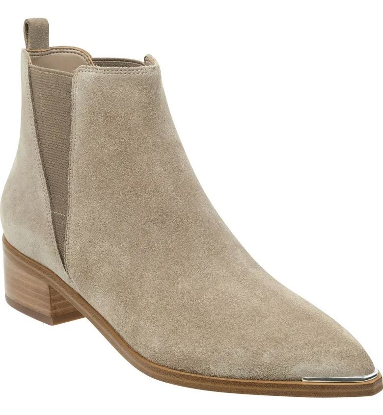 Beige suede ankle boot with a low wooden heel and side elastic panels