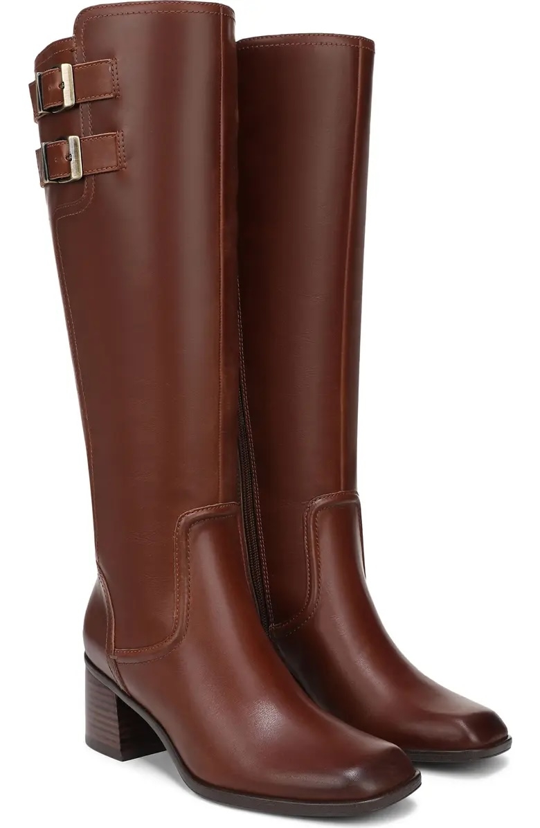Brown knee-high leather boots with buckles and a low block heel, ideal for fall fashion and shopping enthusiasts looking for stylish footwear