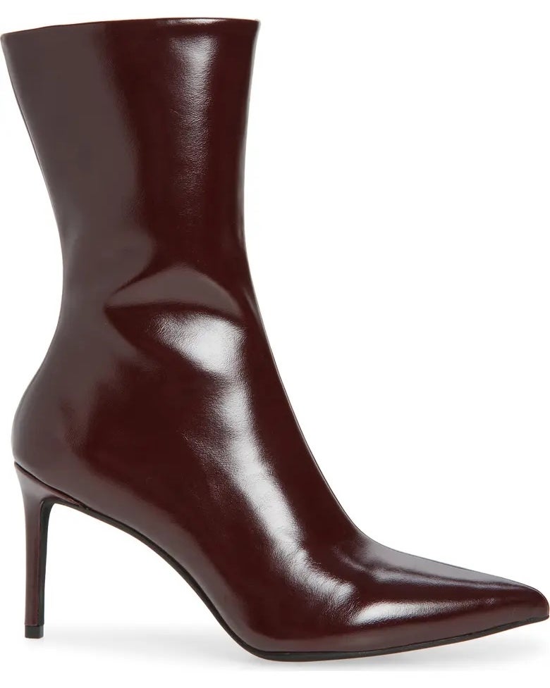 Sleek high-heeled ankle boot with pointed toe and smooth finish, perfect for fashion-forward shopping enthusiasts