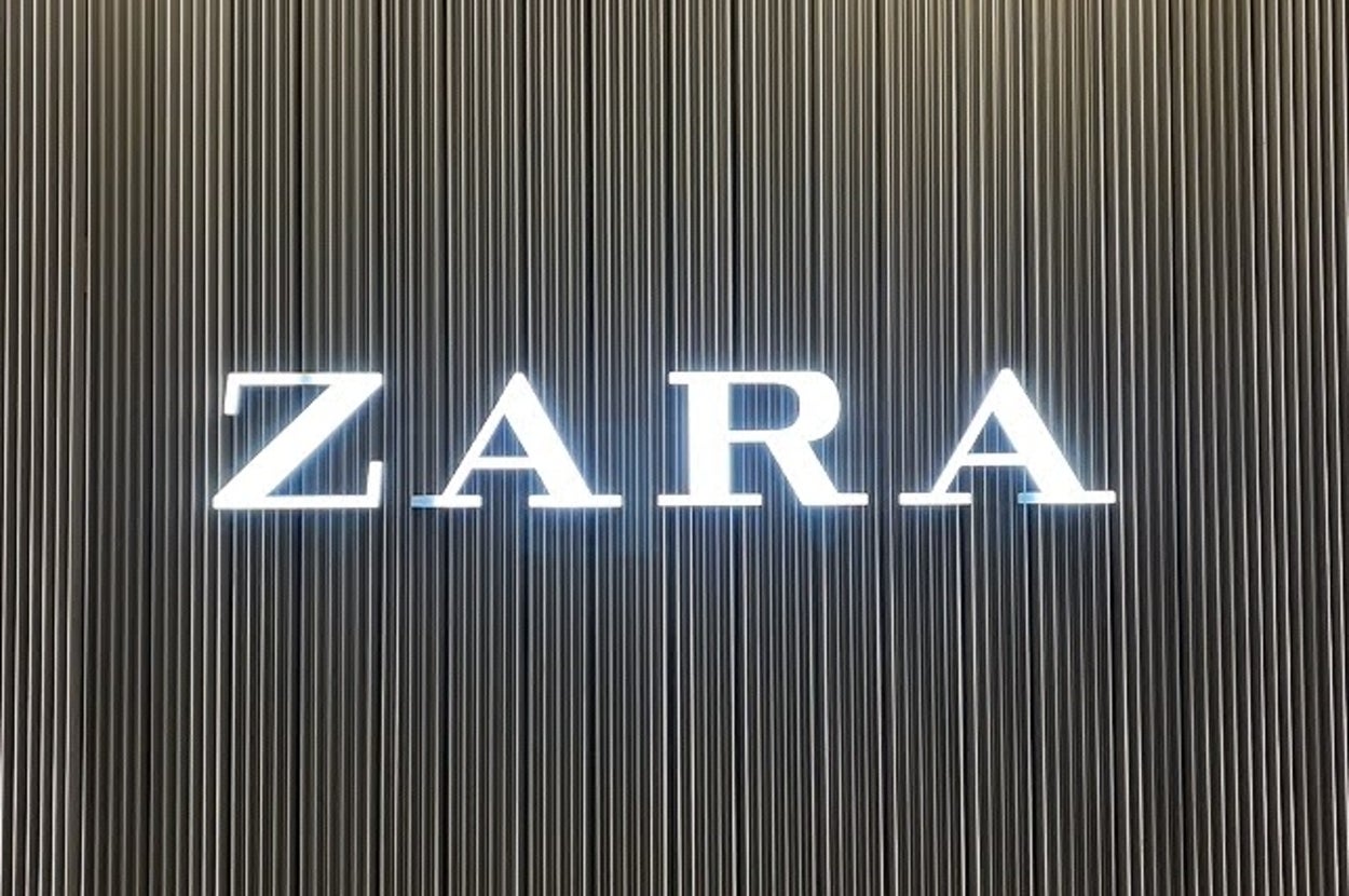 Zara store sign with illuminated lettering on a striped background