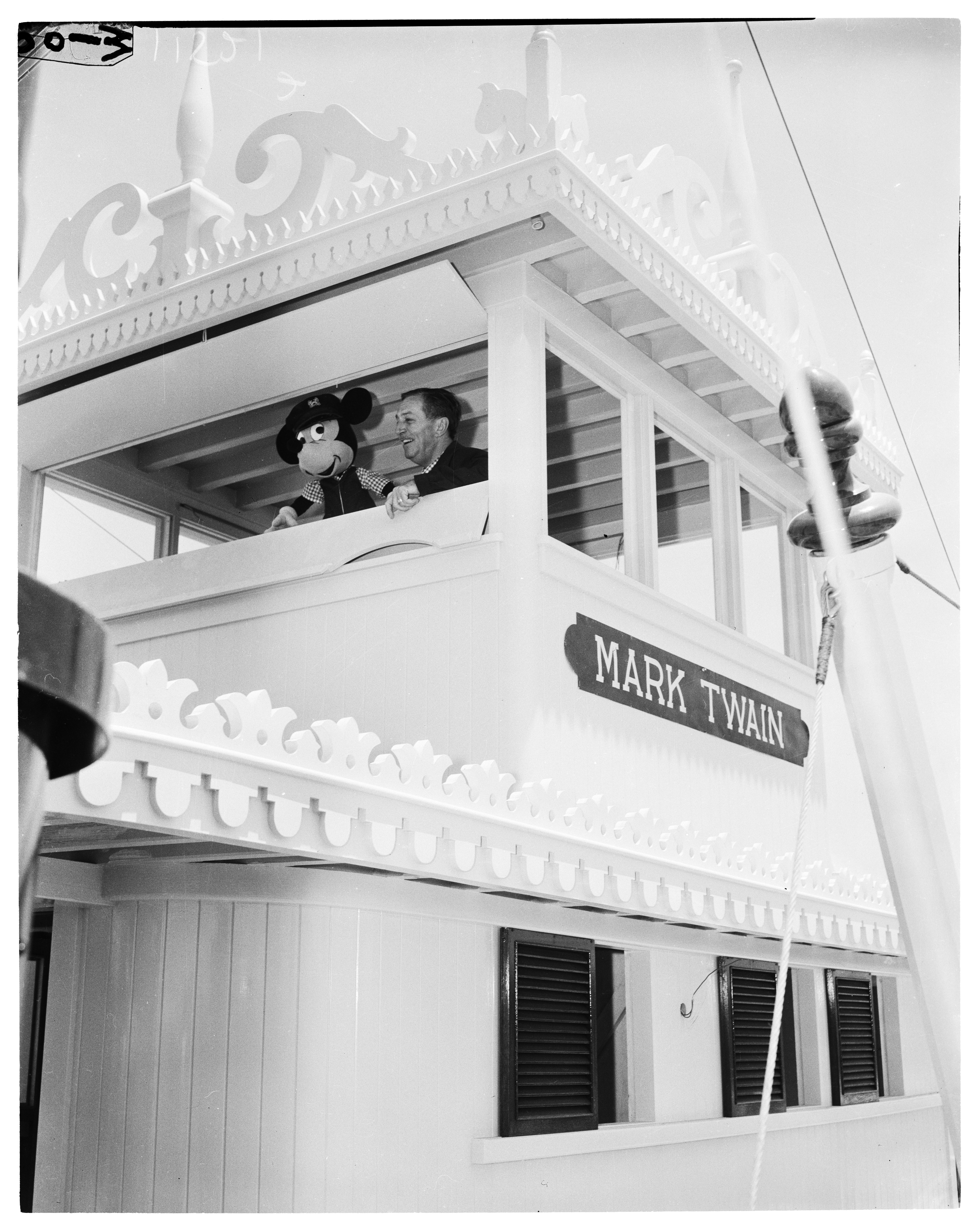 Person lasting  connected  a riverboat named "Mark Twain," holding a ample  puppet