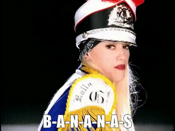 Gwen Stefani in a marching band outfit with hat and red lips, text reads &quot;B-A-N-A-N-A-S&quot;
