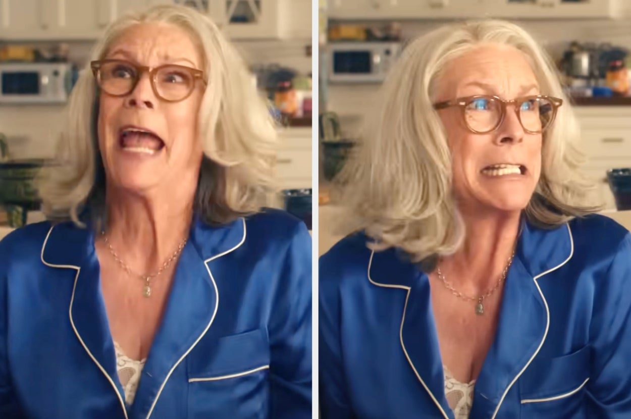 Person wearing glasses and a blue satin sleepwear set in a kitchen, showing surprised and slightly anxious facial expressions