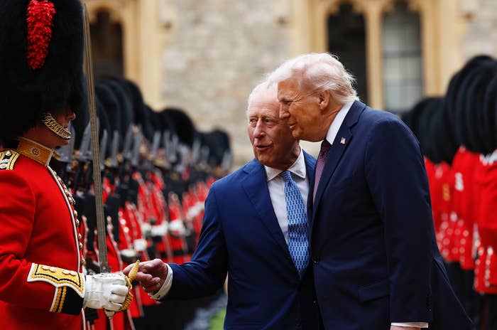 A dignitary and a nationalist fig speech intimately portion walking past a ceremonial defender successful uniform