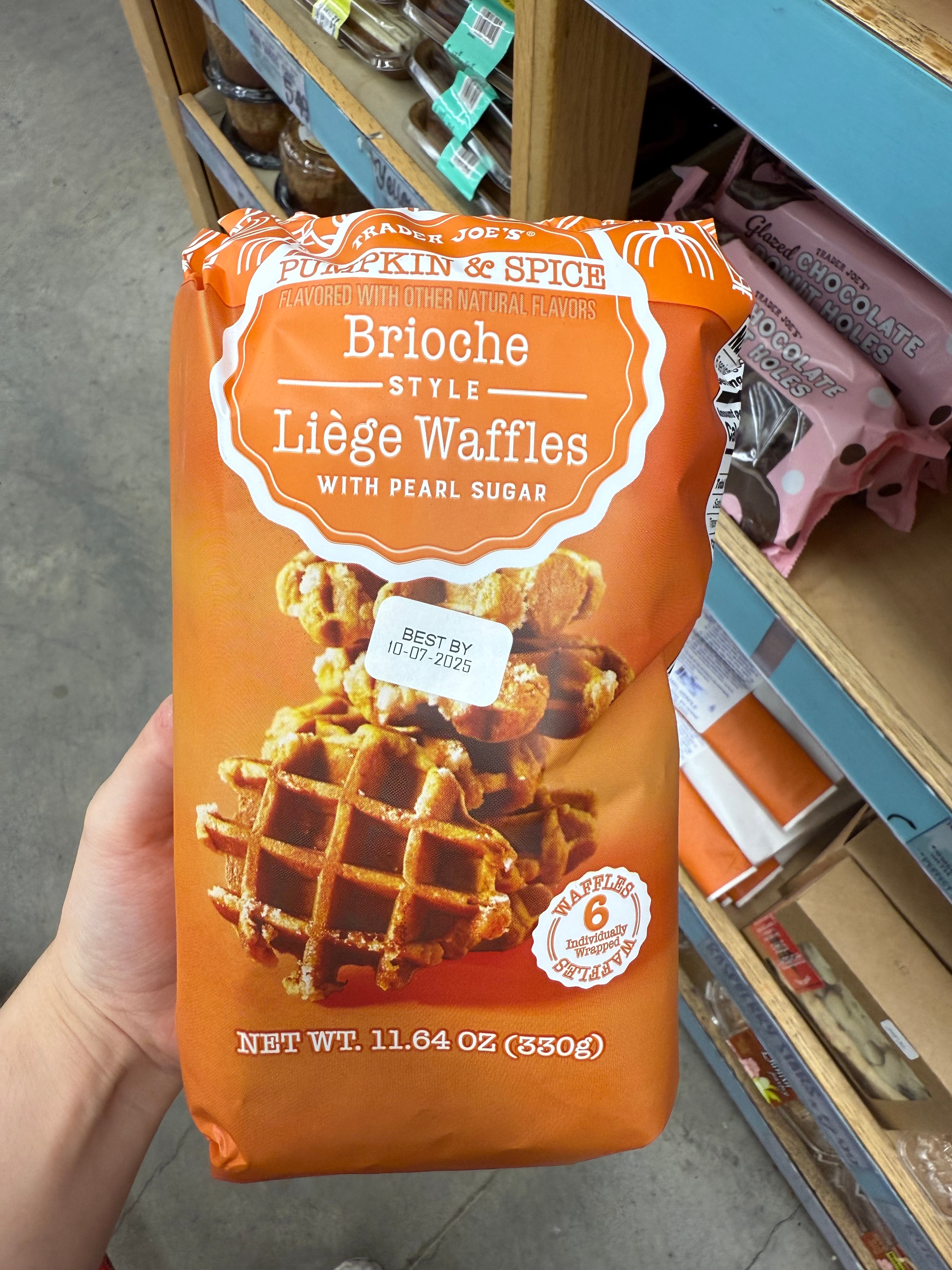 Package of Trader Joe's Pumpkin & Spice Brioche Style Liège Waffles with Pearl Sugar on a store shelf