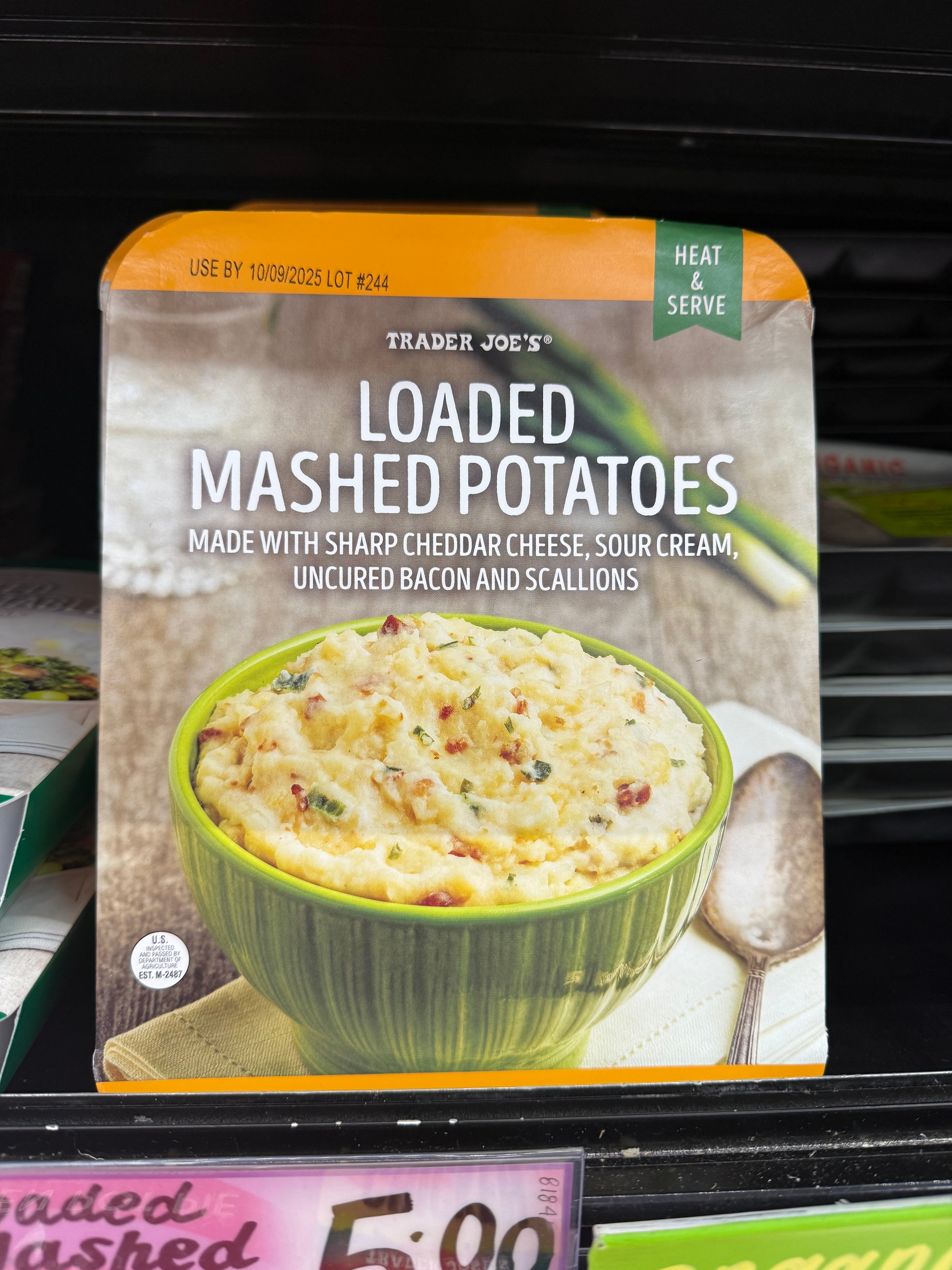 Trader Joe's Loaded Mashed Potatoes packaging: sharp cheddar, sour cream, uncured bacon, scallions. Heat and serve. Use by 10/09/2023. Price: $5.99