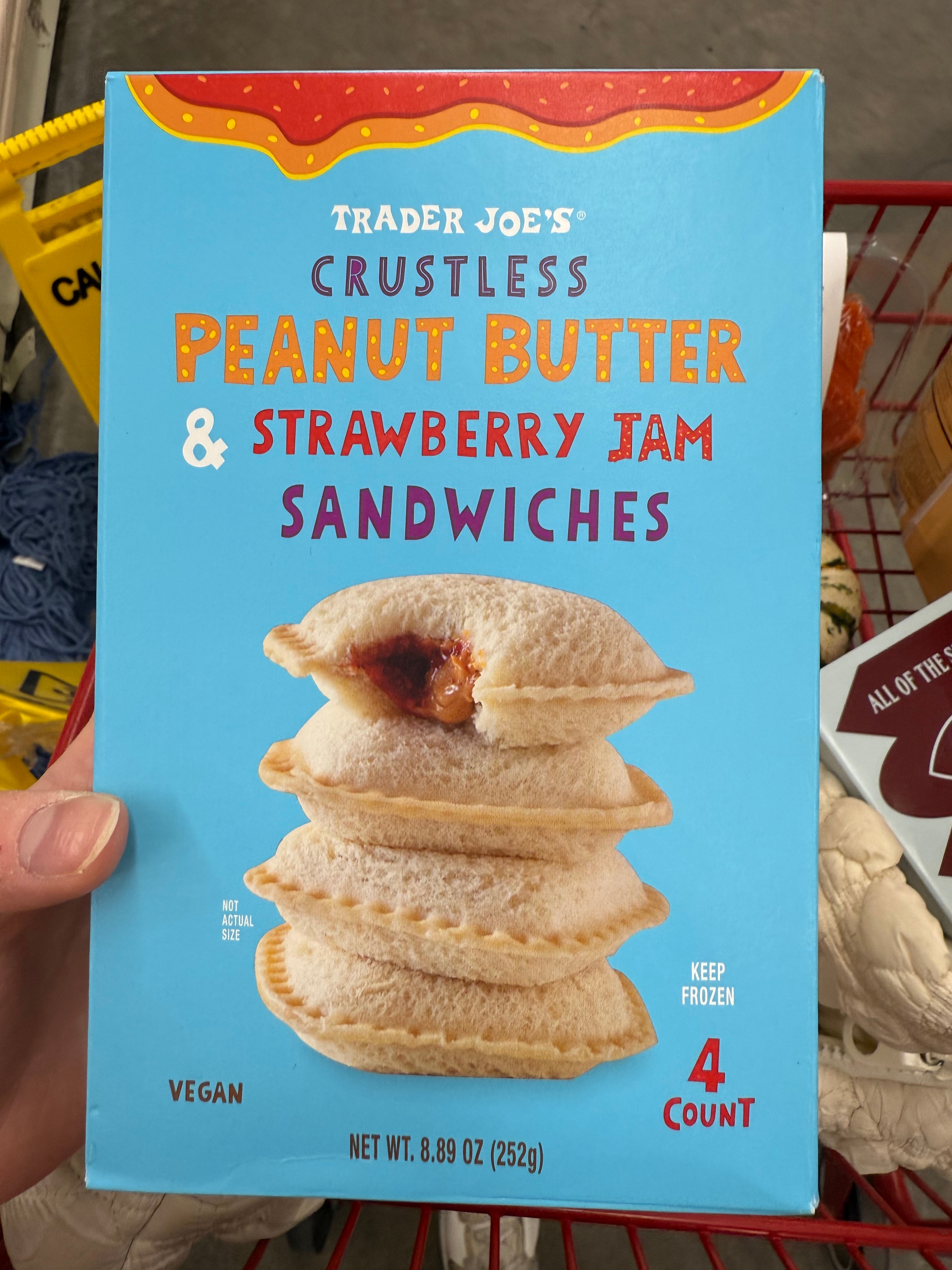Box of Trader Joe&#x27;s crustless peanut butter and strawberry jam sandwiches in a shopping cart