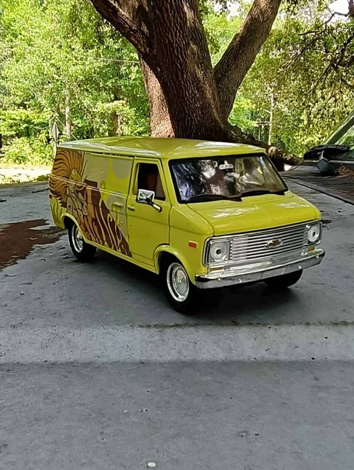 Toy van modeled aft a vintage Chevrolet parked outdoors, featuring a retro plan connected its side