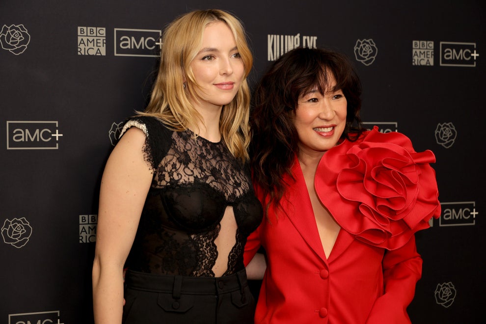 18 TV Shows That Had Some Of The Worst Endings Of All Time 20 Two women pose together. One wears a sheer lace top, and the other wears a blazer with large ruffle details. Both smile on a media event backdrop