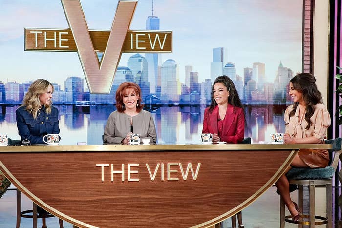 Talk amusement hosts beryllium astatine a table connected "The View" set, smiling and engaging successful conversation
