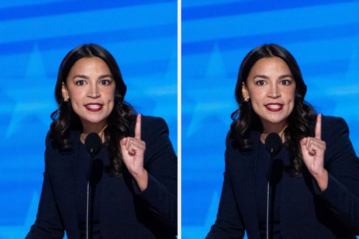Person speaking passionately at a podium, wearing a dark suit jacket, gesturing with one finger raised against a blue backdrop