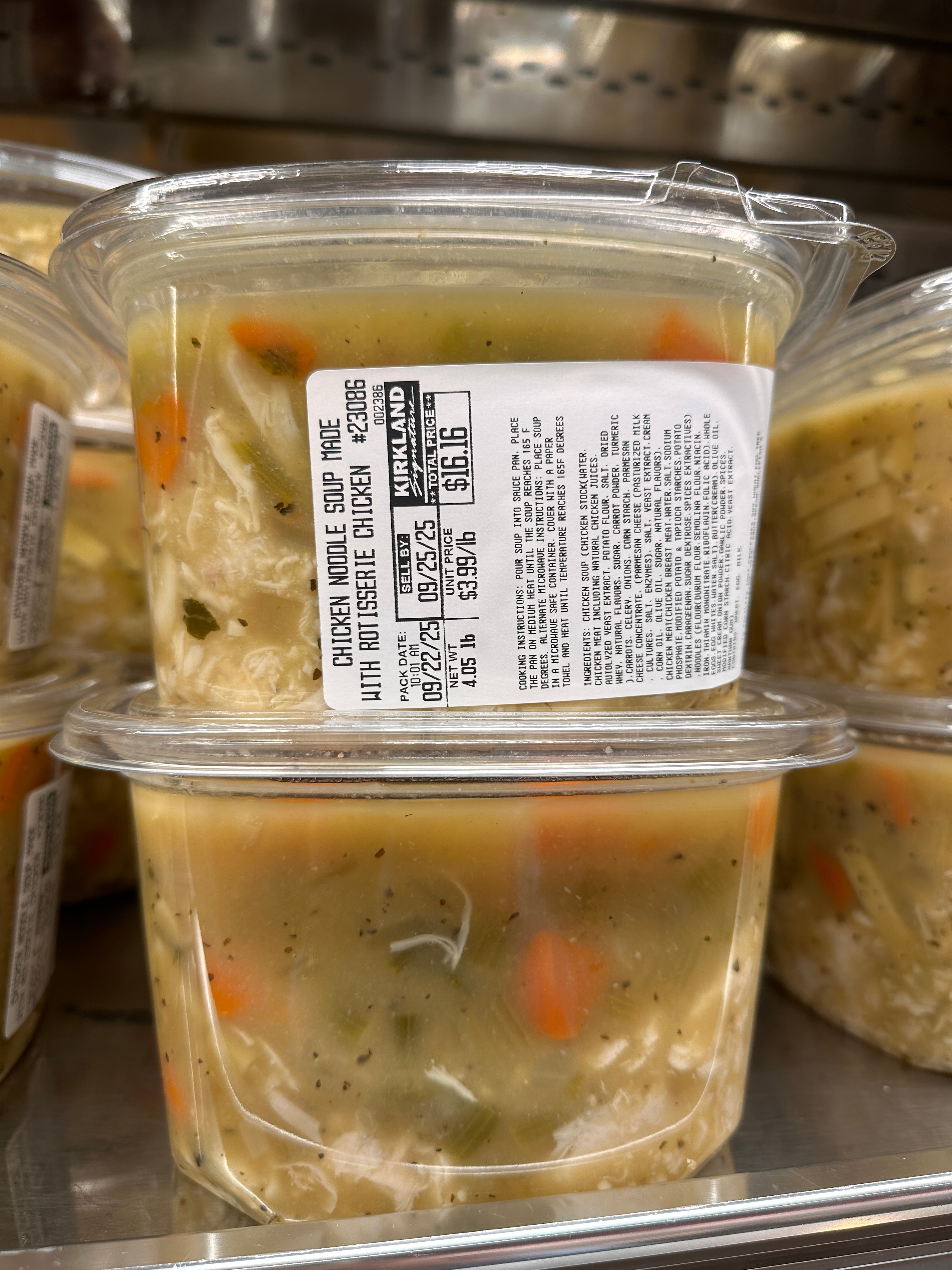 Containers of chicken noodle soup with nutrition labels displayed on a store shelf