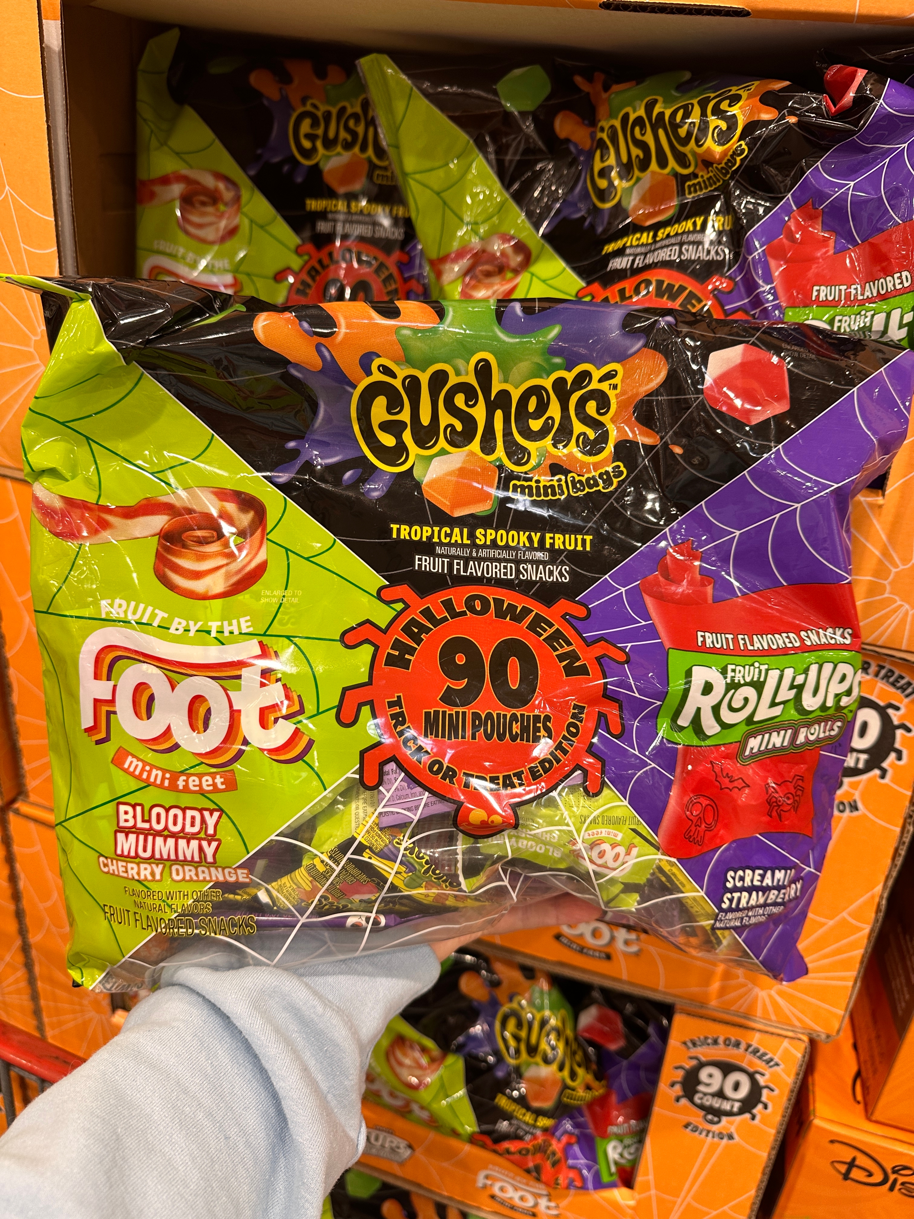 Halloween-themed assorted fruit snacks pack with Gushers, Fruit by the Foot, and Fruit Roll-Ups. Contains 90 mini pouches