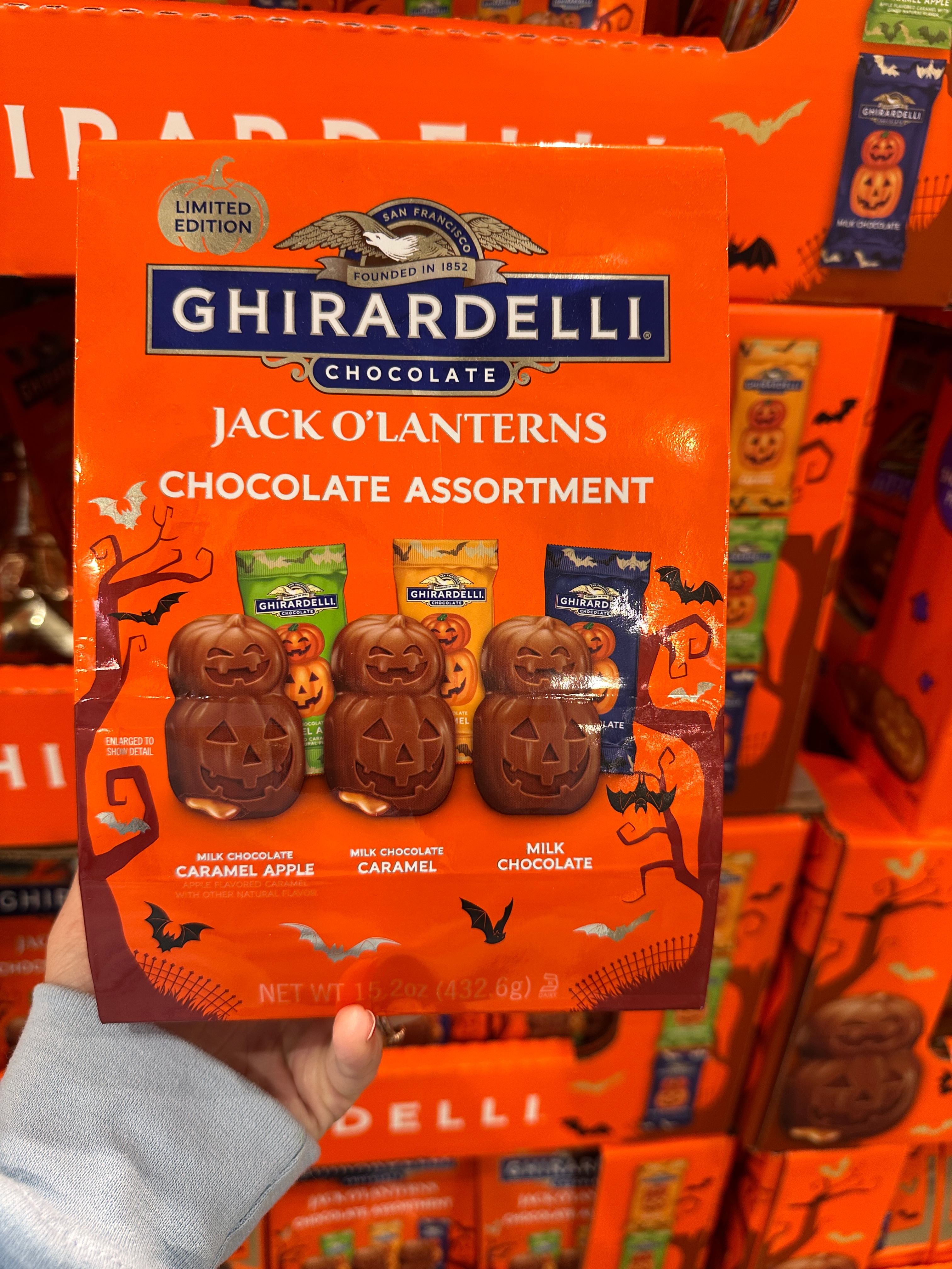 Ghirardelli limited edition chocolate assortment pack featuring pumpkin-shaped chocolates in caramel apple, caramel, and milk chocolate flavors