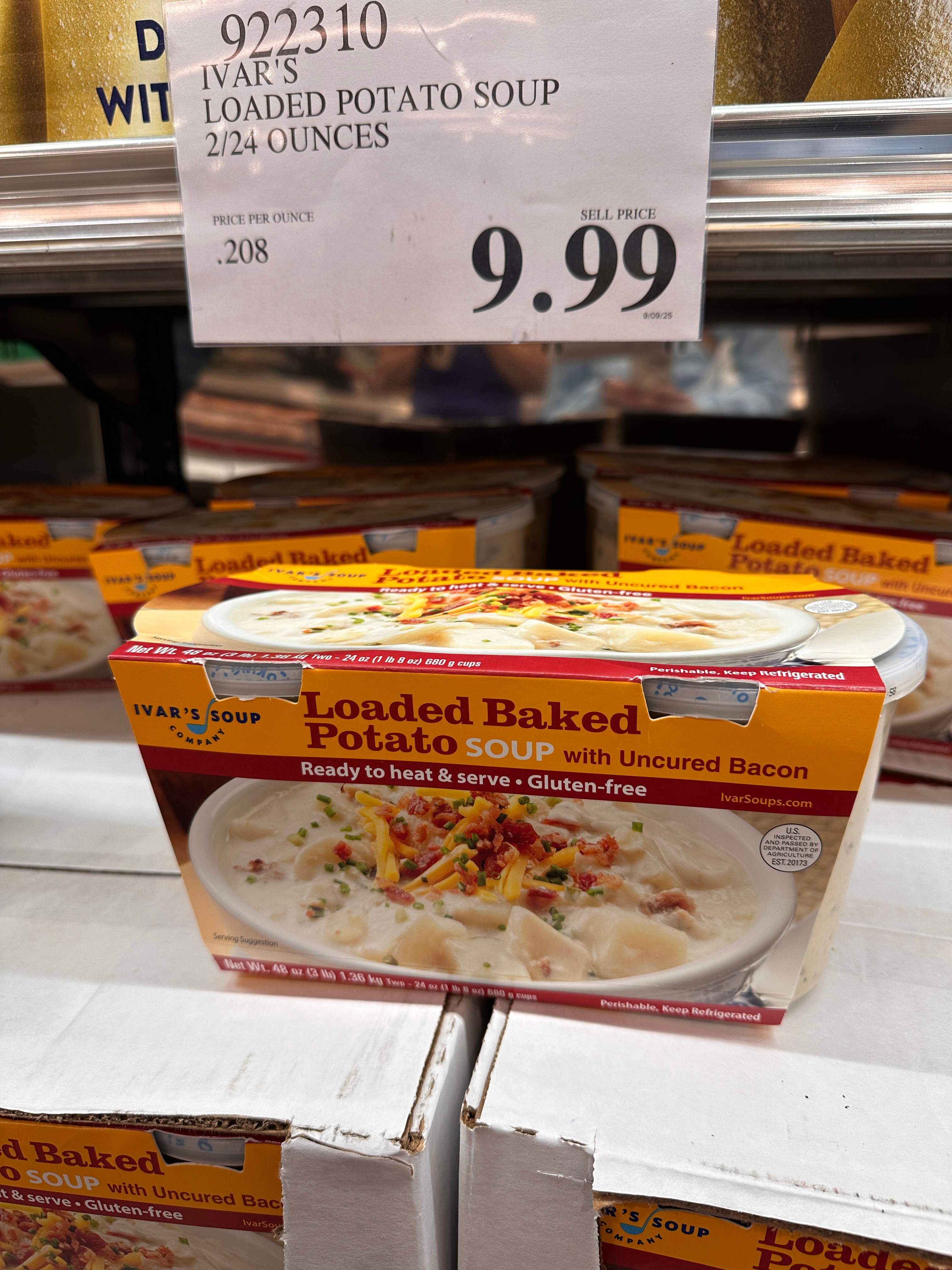 Ivar's Loaded Baked Potato Soup box on a store shelf. Sign above shows price as $9.99 for 2/24 oz. Containers are ready to heat, serve, and gluten-free