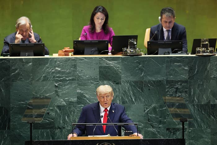 A person speaks at a podium in the United Nations General Assembly, with officials seated behind