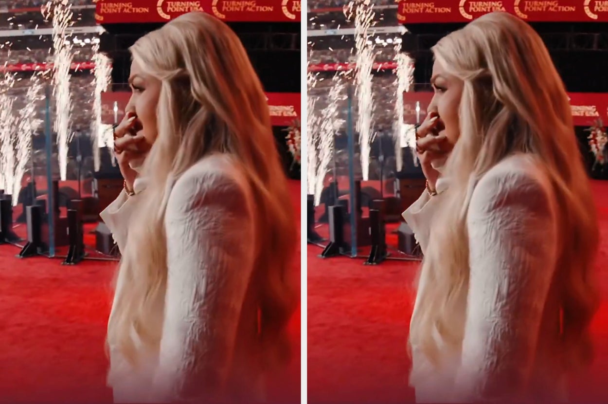 erika on a red carpet with fireworks, covering mouth in a moment of emotion or surprise
