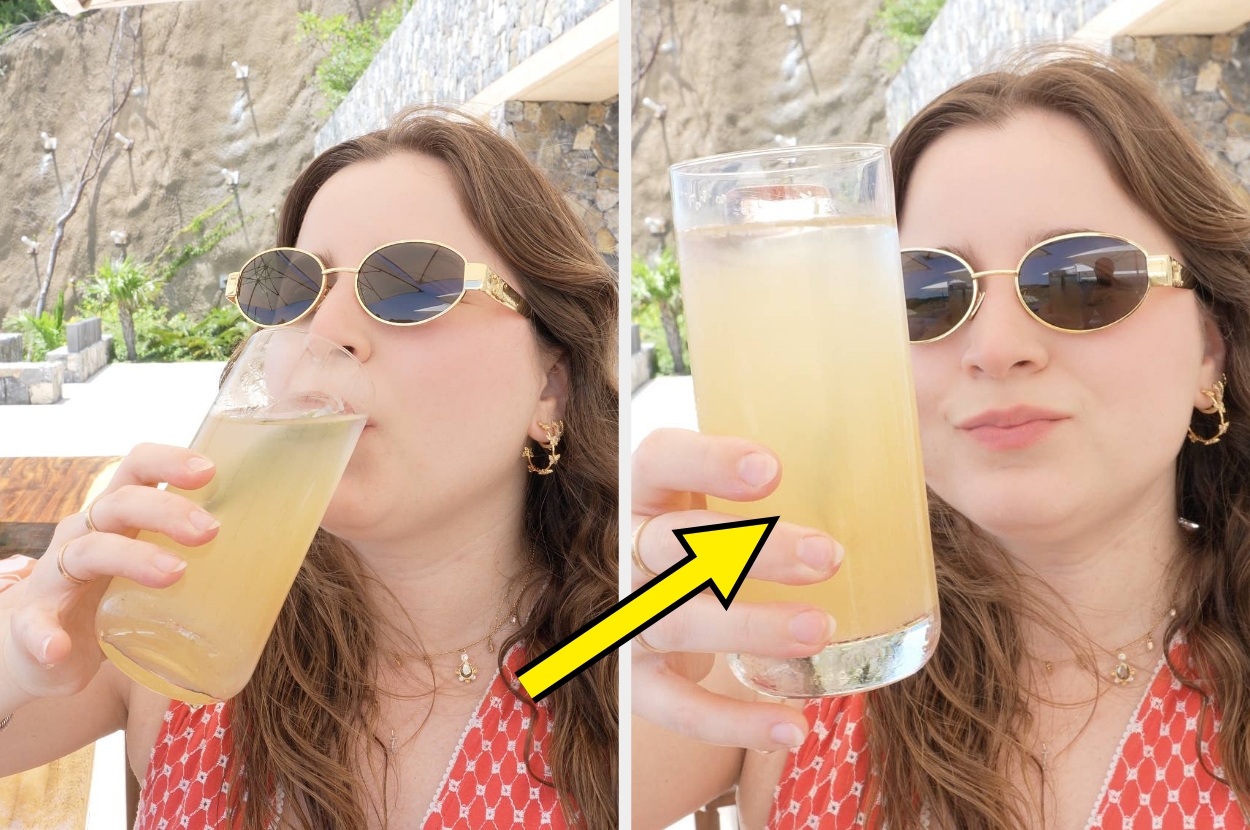 Person in sunglasses drinks a tall glass of lemonade striped attire, enjoying a refreshing beverage outdoors