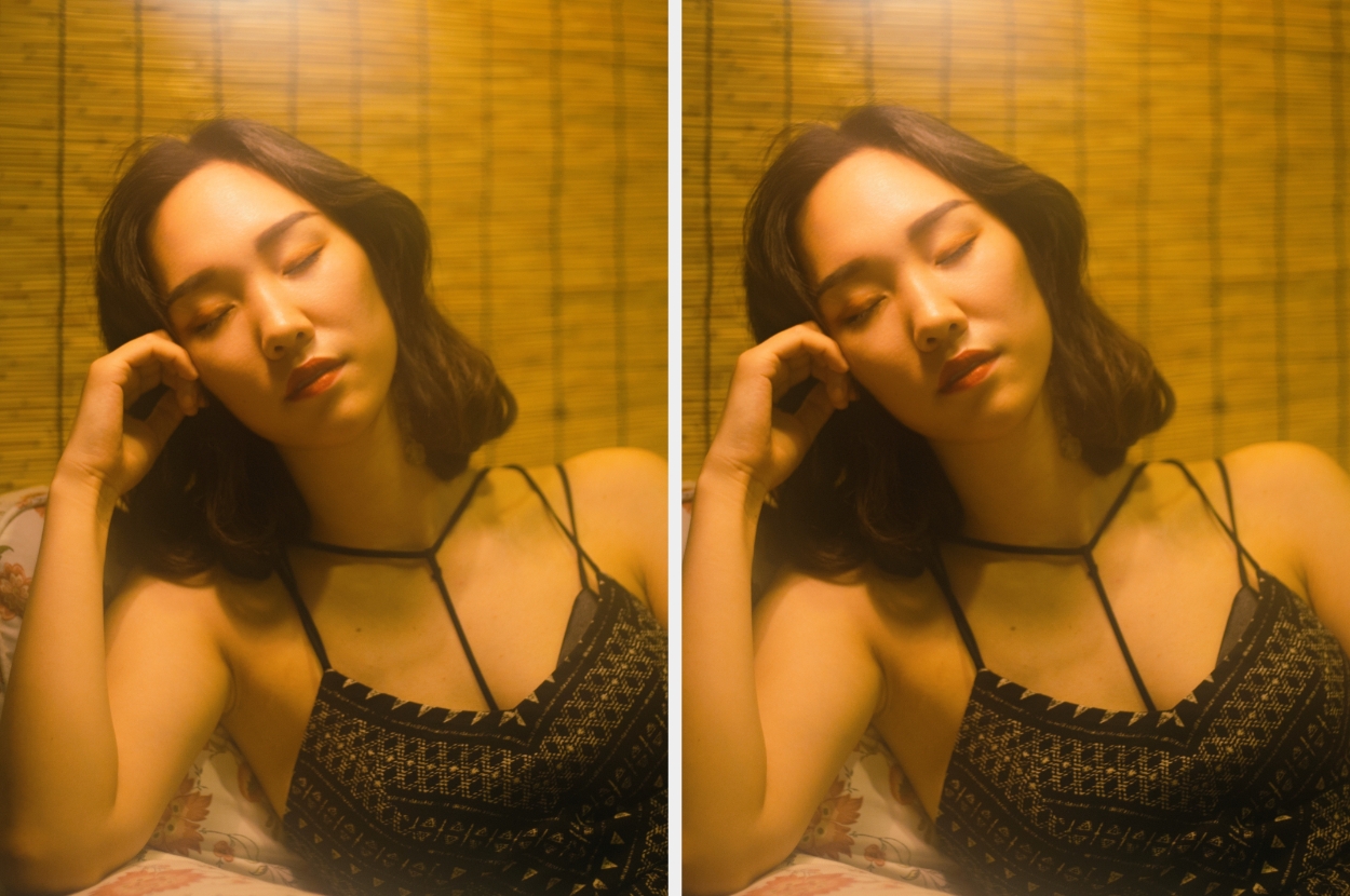 A woman in a sleeveless top relaxes with eyes closed, resting her head on her hand in a serene setting