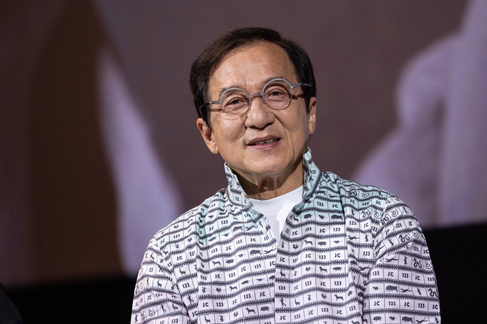 24 Bizarre Celeb Facts That Sound Fake, But Are 100% True 20 A person wearing a patterned button-up shirt and round glasses smiling at an event