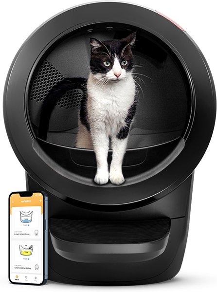 Cat inside a modern, automated litter box with a smartphone app shown beside it for monitoring or control
