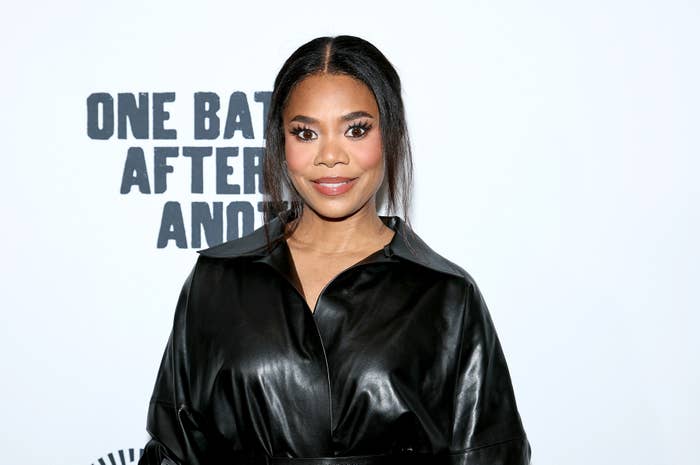 24 Bizarre Celeb Facts That Sound Fake, But Are 100% True 3 Person in leather outfit on red carpet with bold eye makeup and sleek hairstyle, standing in front of text backdrop