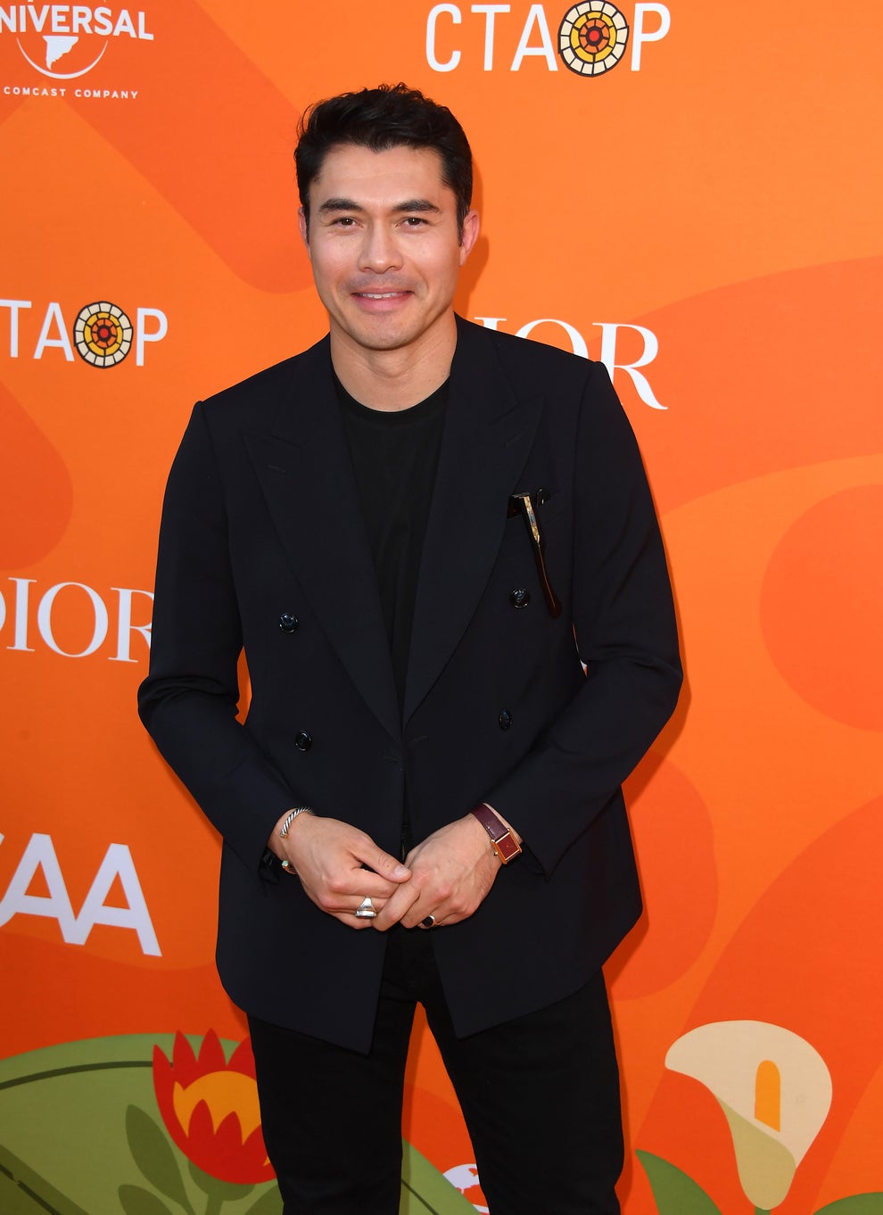 24 Bizarre Celeb Facts That Sound Fake, But Are 100% True 26 Man in tailored black suit on red carpet at a celebrity event, smiling and posing