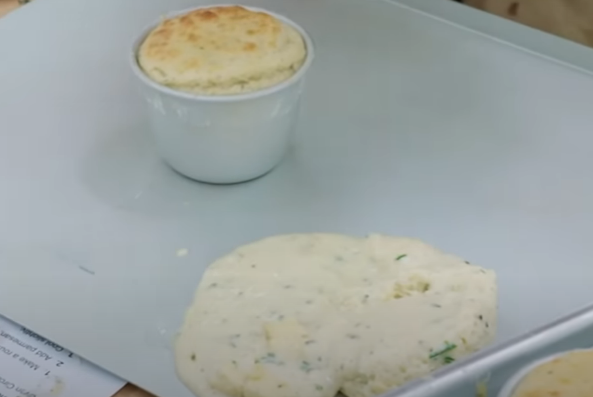 A ramekin with a perfectly risen soufflé next to a flat, collapsed soufflé on a tray