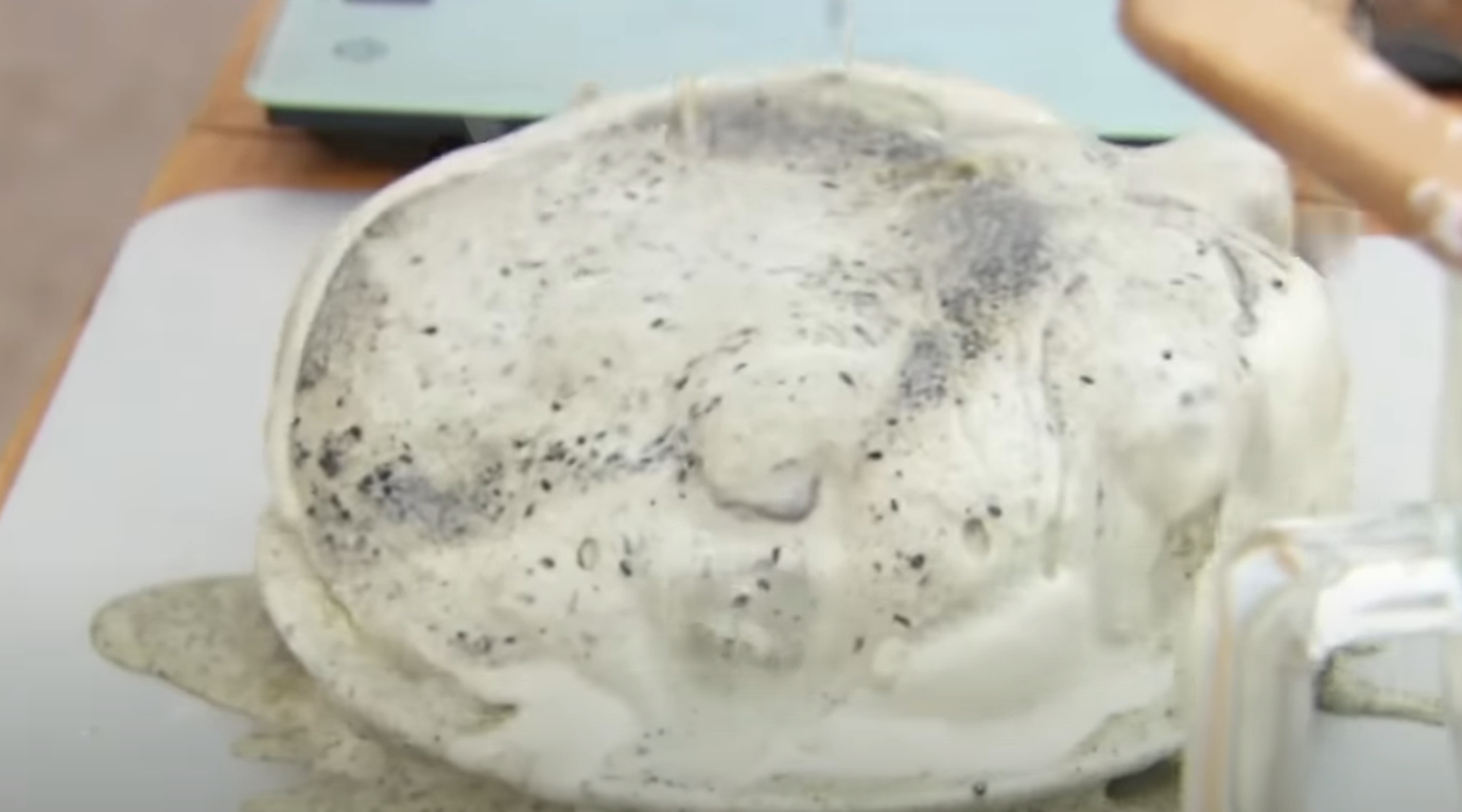 A failed attempt at making a large pancake, showing batter overflow and uneven cooking on a stovetop