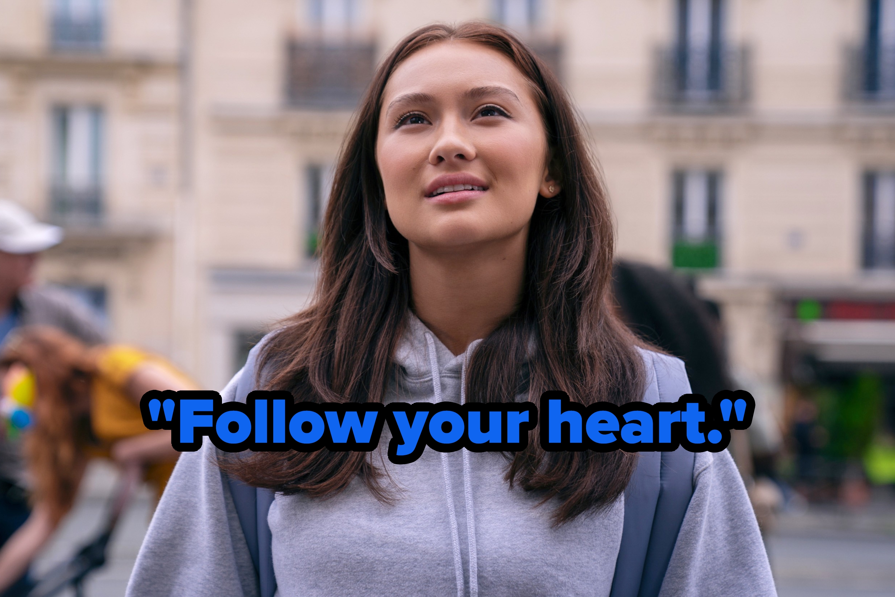 Person wearing a hoodie, looking upward, with the text "Follow your heart." in the foreground