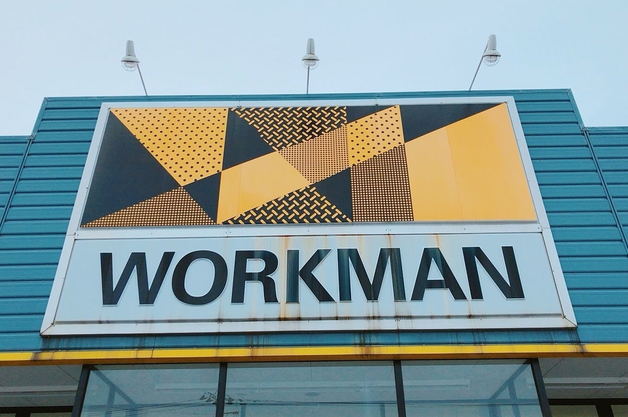 Storefront with a geometric sign above reading "WORKMAN" in bold letters